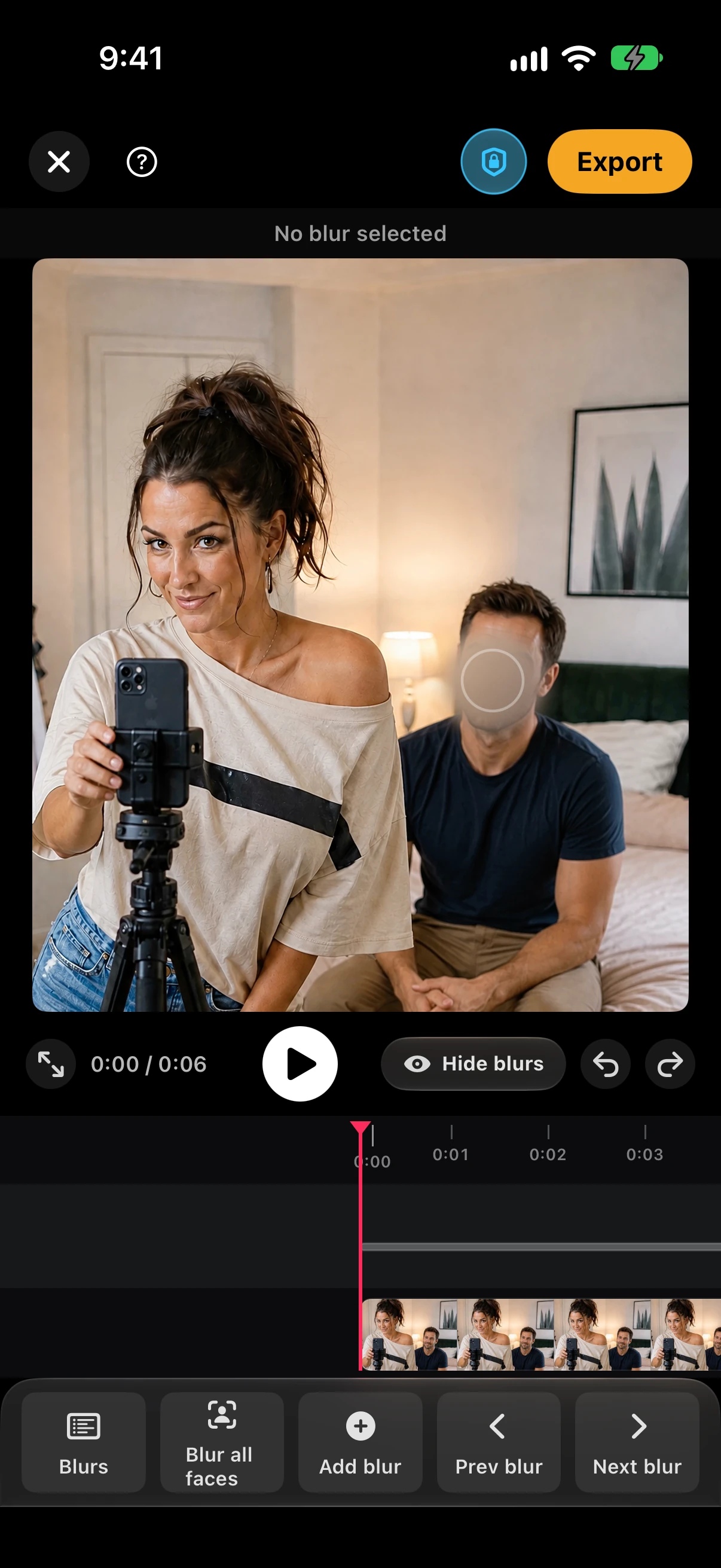 BleepFace video editor with the man on the bed blurred while the creator stays clear